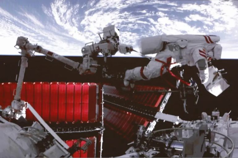 FILE - In this file photo released by Xinhua News Agency, a video screen shows Chinese astronaut Fei Junlong conducting extravehicular activities on the orbiting Tiangong space station, on, Feb. 9, 2023. China says it will soon begin training foreign astronauts for trips to its newly completed orbiting space station. (Liu Fang