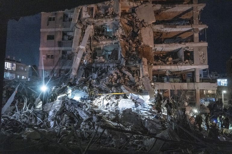 TEL AVIV, ISRAEL JUNE 15: Israeli civil defense and emergency responders conduct nighttime search and rescue operations among heavily damaged buildings following a missile strike by Iran in the southern Tel Aviv suburb of Bat Yam on June 15, 2025. (Photo by Mostafaf Alkharouf/Anadolu via Getty Images)