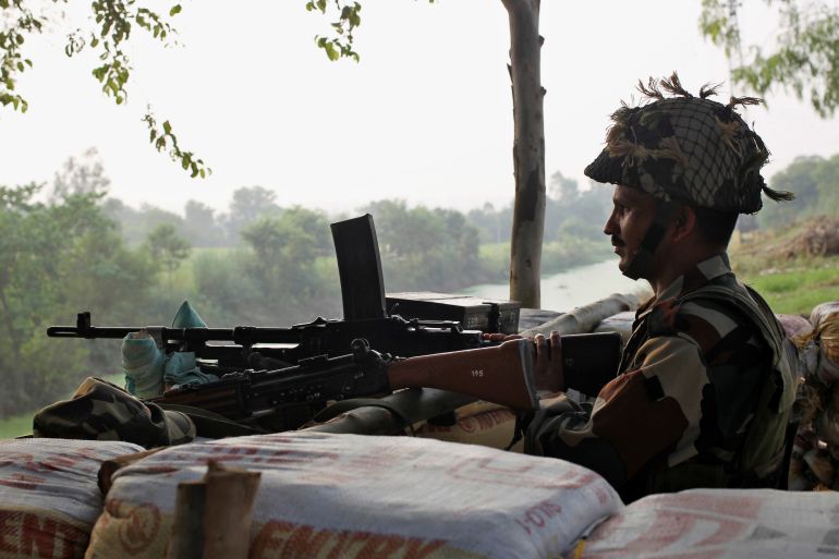 An Indian army soldier keeps guard from a bunker near the border with Pakistan in Abdullian, southwest of Jammu, September 30, 2016. REUTERS/Mukesh Gupta