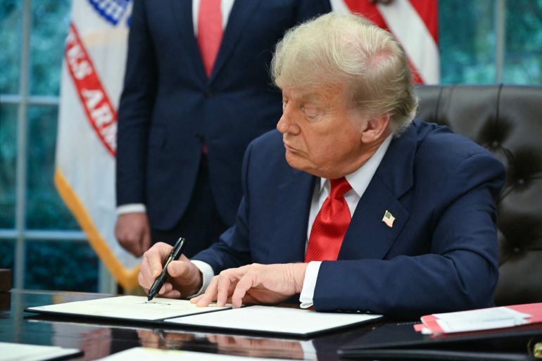 US President Donald Trump signs a letter addressed to Rwandan President Paul Kagame congratulating him on the peace agreement with Democratic Republic of the Congo during a meeting with Democratic Republic of the Congo Foreign Minister Thérèse Kayikwamba Wagner and Rwandan Foreign Minister Olivier Nduhungirehe (not pictured) in the Oval Office of the White House in Washington, DC, on June 27, 2025.