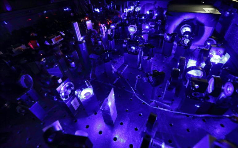 View of the laser of the optical lattice clocks (OLC) in a laboratory at the Paris Observatory July 22, 2013. France-based physicists have designed a clock whose use of laser beams to measure atomic vibrations makes it up to three times more accurate than atomic clocks and could lead to a more precise definition of the second. The team of five researchers at the Paris Observatory says the new timekeeper is so accurate it will neither gain nor lose a second over a period of 300 million years, against 100 million years for the atomic clocks around the world that set time. While such a high degree of precision may seem a scientist's fad, it could improve the resolution of global positioning systems (GPS), help smartphones download data faster and refine high-frequency trading on financial markets, already measured in microseconds (millionths of a second). Picture taken July 22, 2013. REUTERS/Philippe Wojazer (FRANCE - Tags: SCIENCE TECHNOLOGY) Laser