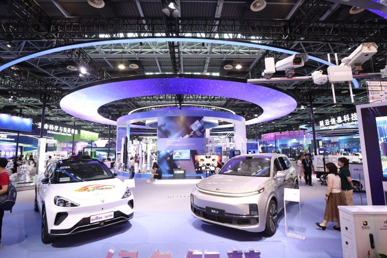 BEIJING, CHINA - MAY 28: A Baidu Apollo self-driving car and Li Auto L9 car are on display during the exhibition of 2023 Zhongguancun Forum (ZGC Forum) on May 28, 2023 in Beijing, China. (Photo by Chen Xiaogen/VCG via Getty Images)