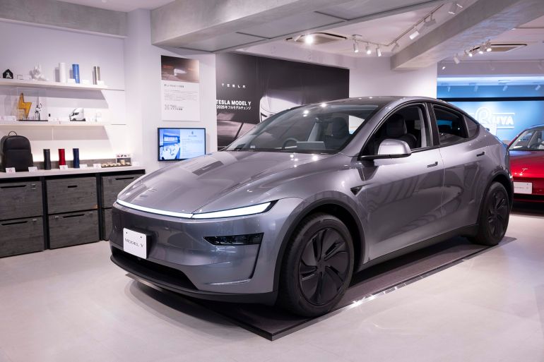 JAPAN - 2025/04/25: Tesla model Y on display inside the Tesla pop-up store near Shibuya crossing. In April 2025, Tesla opened a pop-up store in Shibuya, Tokyo, strategically located just a minute's walk from Shibuya Station. The store showcases the new Model Y and Model 3, along with the Optimus robot, offering an interactive experience for visitors. This temporary setup aims to boost brand visibility and engage potential customers in one of Tokyo's busiest districts, aligning with Tesla's strategy to expand its presence in Japan's electric vehicle market. (Photo by Stanislav Kogiku/SOPA Images/LightRocket via Getty Images)