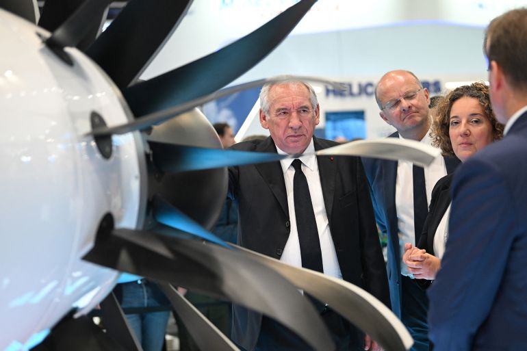 French Prime Minister François Bayrou visits the stand of French aircraft manufacturer Dassault Aviation during the 55th edition of the International Paris Air Show at the Paris–Le Bourget Airport, in Le Bourget, suburb of Paris on June 16, 2025. (Photo by JEANNE ACCORSINI / POOL / AFP)