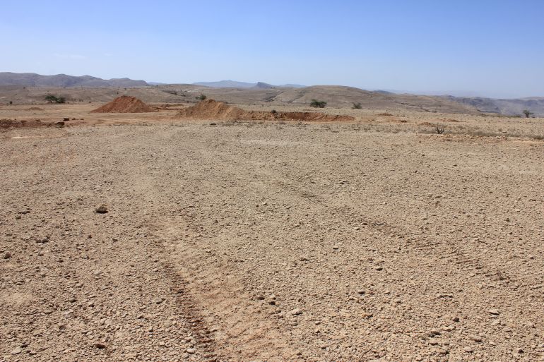 The arid desert ground being prepared for the construction of an asphalt road at Selma plateau in the Sultanate of Oman. The famous Majlis Al Jinn or 'Meeting place of the Spirits' is in Selma.; Shutterstock ID 1479477443; purchase_order: ي; job: ; client: ; other:
