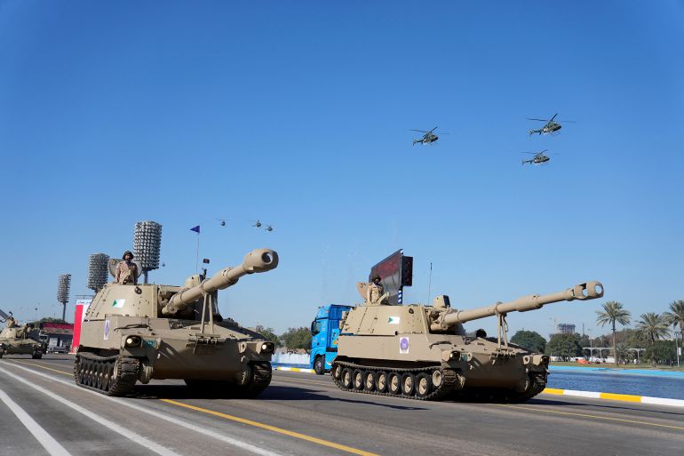 Iraqi Army tanks drive under the Victory Arch during the Army Day celebrations in Baghdad, Iraq, Saturday, Jan. 6, 2024. The Iraqi Army was activated on Jan. 6, 1921 while under British rule. Hadi Mizban/Pool via REUTERS