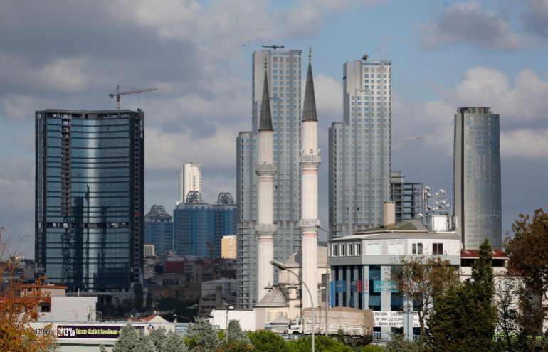 Residential towers are seen behind a mosque in Istanbul's Sisli district in this September 3, 2012 file photo. The developer of a five-tower luxury compound perched on the edge of the new financial district on Istanbul's Asian side is putting the finishing touches to a complex that will boast eco-friendly apartment blocks, swimming pools and lush green parks. It is the sort of development that overseas property buyers in Turkey, mainly from Europe, have usually shied away from, investing instead in holiday homes along the country's Mediterranean and Aegean shores. But a new wave of wealthy investors from the Middle East and Russia is increasingly eyeing luxury developments in bustling Istanbul, lured by a relaxation in property laws, relatively cheap prices and a thriving economy. Picture taken September 3, 2012. To match TURKEY-PROPERTY/ (MIDEAST MONEY) REUTERS/Murad Sezer (TURKEY - Tags: BUSINESS REAL ESTATE SOCIETY WEALTH)