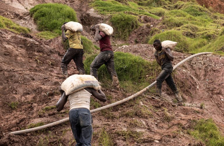 Labourers carry sacks of ore at the Rubaya coltan mine, in the town of Rubaya, which is controlled by M23 rebels, in the eastern Democratic Republic of Congo March 24, 2025. REUTERS/Zohra Bensemra
