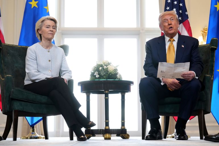 President Donald Trump reads from a paper and European Commission President Ursula von der Leyen listens after reaching a trade deal between the U.S. and the EU at the Trump Turnberry golf course in Turnberry, Scotland Sunday, July 27, 2025. (AP Photo/Jacquelyn Martin)