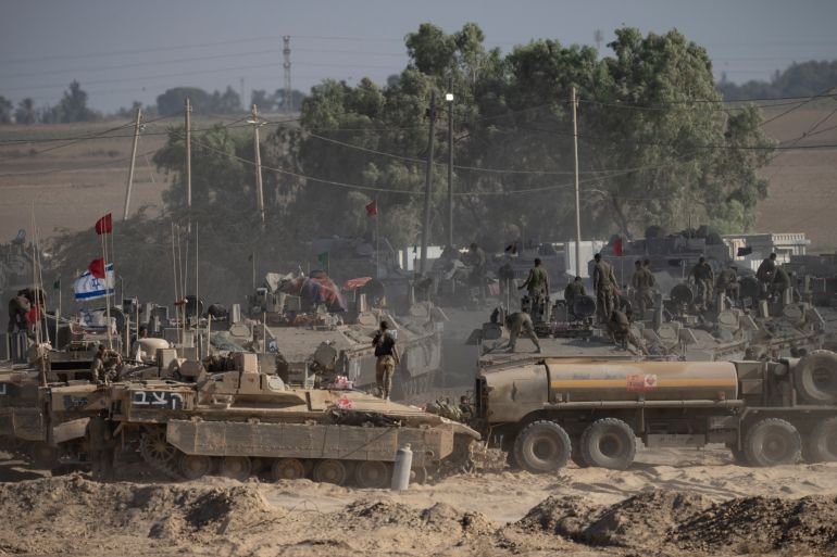 SOUTHERN ISRAEL, ISRAEL - AUGUST 6: Israeli soldiers organize military equipment while standing on armored personnel carriers near the border with the Gaza Strip on August 6, 2025 in Southern Israel, Israel. According to Israeli media reports, senior officials have confirmed Prime Minister Benjamin Netanyahu intends to seek backing from his security cabinet for the "full occupation" of the Gaza Strip, despite dissent within his staff and condemnation by the international community. UN Assistant Secretary General Miroslav Jenca has warned that the plan could endanger the lives of more Palestinians and Israeli hostages held by Hamas. (Photo by Amir Levy/Getty Images)