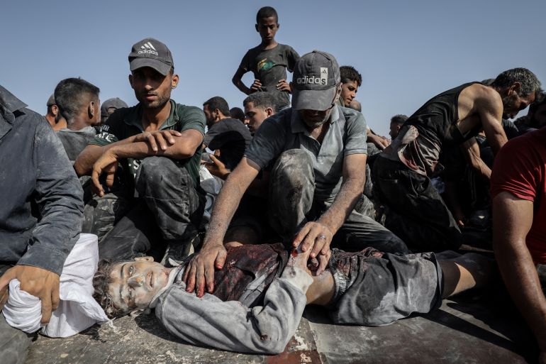GAZA CITY, GAZA - AUGUST 2: (EDITORS NOTE: Image depicts death) Palestinians carry the bodies after the Israeli forces opened fire on Palestinians waiting for humanitarian aid in the northern Gaza area of Zikim Crossing in Gaza City, Gaza on August 2, 2025. Survivors and witnesses rushed to evacuate the wounded and the dead from the area. ( Khames Alrefi - Anadolu Agency )