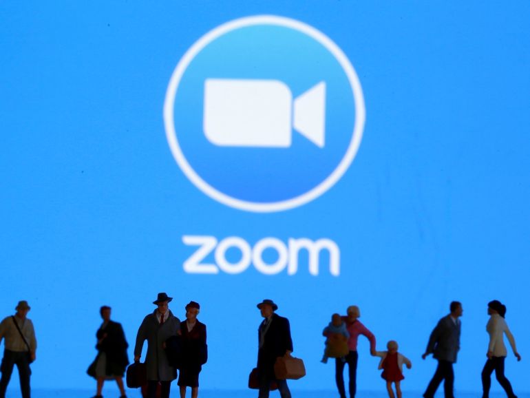 Small toy figures are seen in front of diplayed Zoom logo in this illustration taken March 19, 2020. REUTERS/Dado Ruvic/Illustration