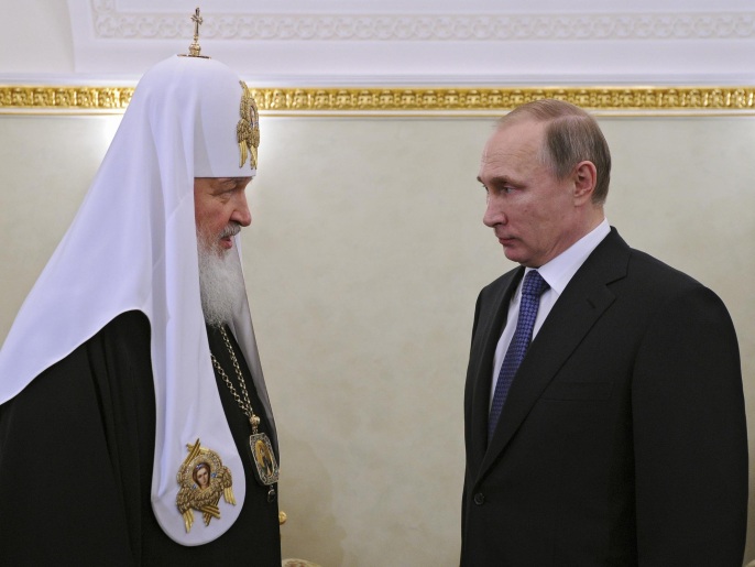 Russian President Vladimir Putin congratulates Russian Orthodox Church Patriarch Kirill, left, on the anniversary of his enthronement in Moscow's Kremlin, Russia, Monday, Feb. 1, 2016. Kirill became patriarch on this day in 2009. (Alexei Nikolsky/Sputnik, Kremlin Pool Photo via AP)