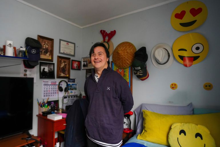 Actor Sebastián Solorza, who has Down syndrome and aims to run for president as an independent candidate, smiles during an interview at his home in Santiago, Chile, Thursday, July 31, 2025. (AP Photo/Esteban Felix)