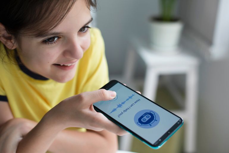 Happy girl using system AI Chatbot in computer or mobile application. Chatbot conversation, Ai Artificial Intelligence technology. Open AI generate. Futuristic technology. Virtual assistant on internet.