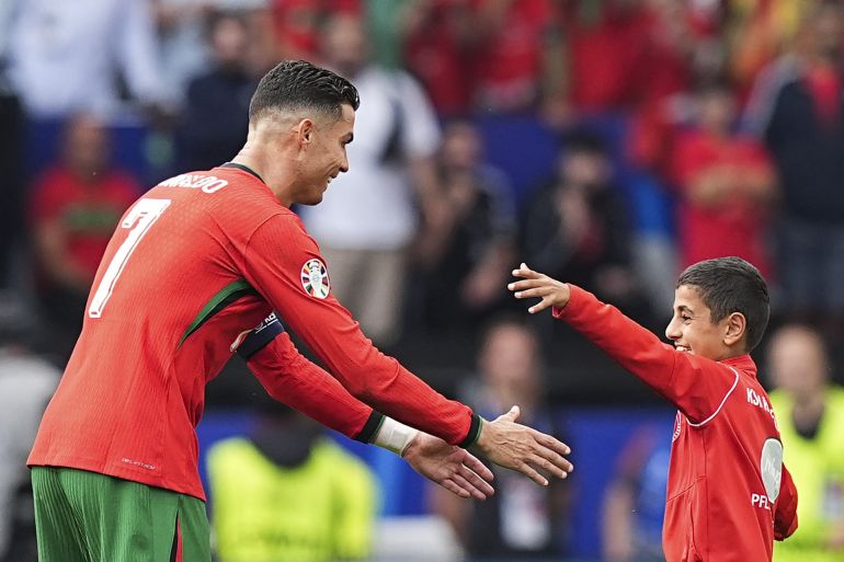 DORTMUND, GERMANY - JUNE 22: A kid takes a selfie with Cristiano Ronaldo during UEFA EURO 2024 Group F football match between Turkiye and Portugal at Westfalenstadion in Dortmund, Germany on June 22, 2024. (Photo by Emin Sansar/Anadolu via Getty Images)