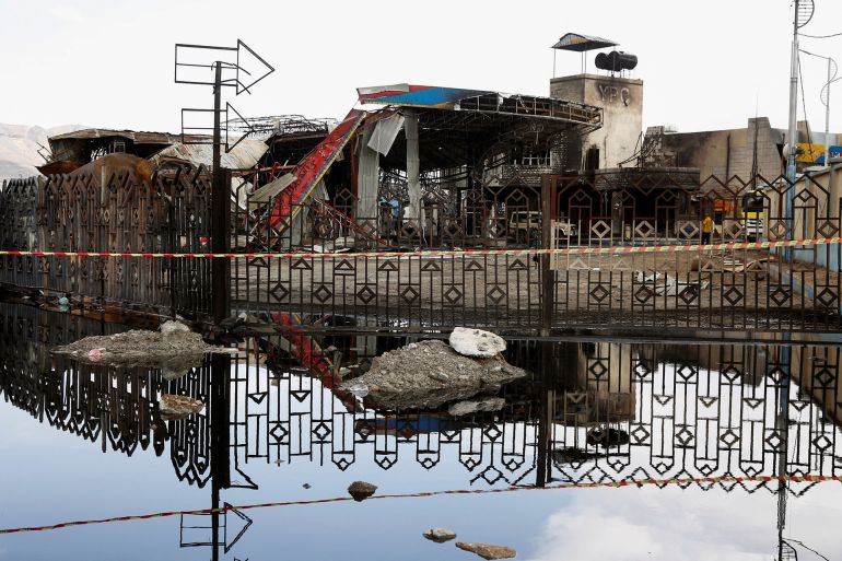 A destroyed fuel station is reflected in a pool of water one day after Israeli airstrikes hit the station in Sanaa, Yemen, August 25, 2025. REUTERS/Stringer