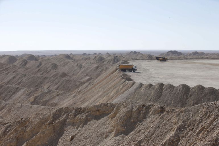 A vehicle carries untreated phosphate after being dropped off on a mountain at a phosphate mine at Boucraa factory of the National Moroccan phosphate company (OCP) situated in the southern provinces
