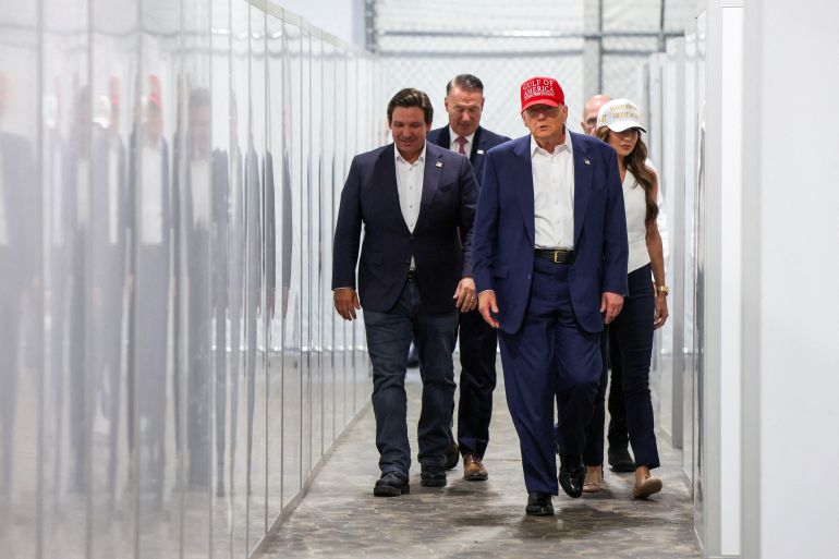 FILE PHOTO: U.S. President Donald Trump, Florida Governor Ron DeSantis and U.S. Homeland Security Secretary Kristi Noem visit a temporary migrant detention center informally known as "Alligator Alcatraz" in Ochopee, Florida, U.S., July 1, 2025. REUTERS/Evelyn Hockstein/File Photo