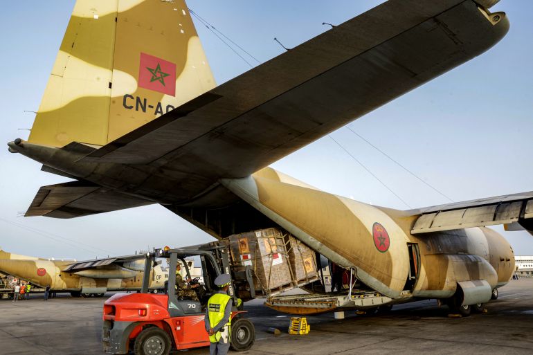 TOPSHOT - Humanitarian aid packages bound for Palestinians in the Gaza Strip are loaded into the back of a Royal Moroccan Air Force C-130 Hercules military transport aircraft at Kenitra Air Base north of Rabat on August 2, 2025, to be eventually unloaded at Israel's Ben Gurion airport and transported to the Kerem Shalom crossing.