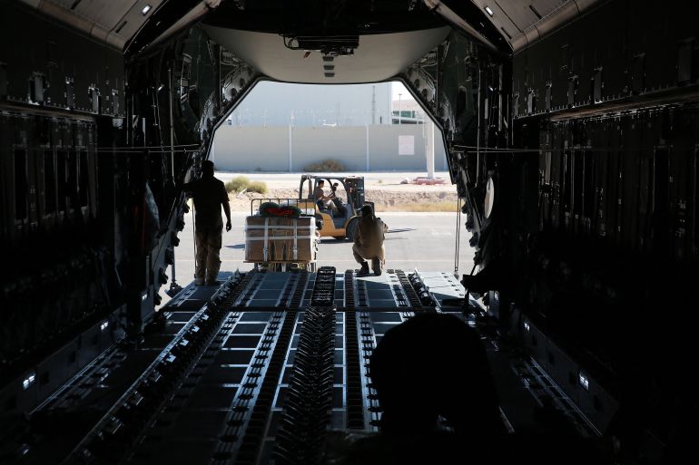 A German Air Force (Luftwaffe) airman uses a forklift to load a humanitarian aid pallet into the cargo bay of an A400M Atlas military transport aircraft on the tarmac at King Abdullah II airbase in Zarqa, Jordan, on August 5, 2025, before taking off for a humanitarian aid airdrop mission over the Gaza Strip.
