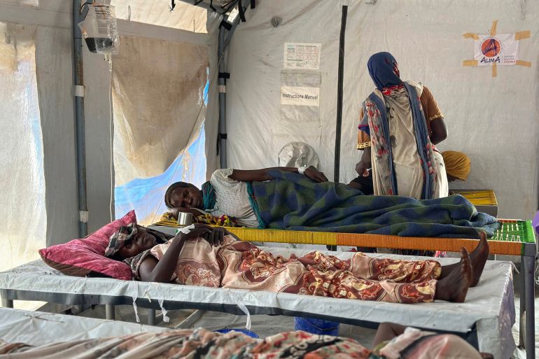 Cholera infected patients receive treatment in the cholera isolation centre at the refugee camps of western Sudan, in Tawila city in Darfur, on August 14, 2025.