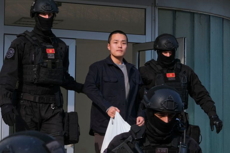 FILE - Montenegrin police officers escort South Korean citizen, Terraform Labs founder Do Kwon in Montenegro's capital Podgorica, March 23, 2024. (AP Photo/Risto Bozovic, File)