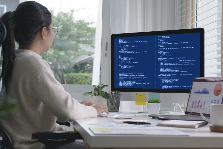 Back rear view of young asian woman, freelance data scientist work remotely at home coding programing on Big data mining, AI data engineering, IT Technician Works on Artificial Intelligence Project.; Shutterstock ID 1854821353; purchase_order: d; job: ; client: ; other: