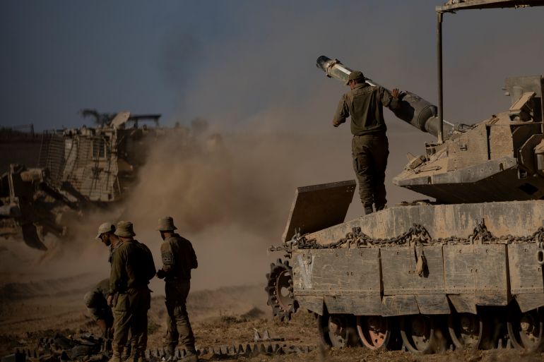 SOUTHERN ISRAEL, ISRAEL - JULY 23: Israeli soldiers stand near a tank near the border with the Gaza Strip on July 23, 2025 in Southern Israel, Israel. Earlier today, a group of more than 100 aid organizations, including Save the Children and MÈdecins Sans FrontiËres (Doctors Without Borders), issued an open letter warning of mass starvation in Gaza and imploring Israeli authorities to provide safe access to food aid. The aid groups also called for a ceasefire, opening of border crossings, and the distribution of food aid through a "UN-led mechanism." (Photo by Amir Levy/Getty Images)
