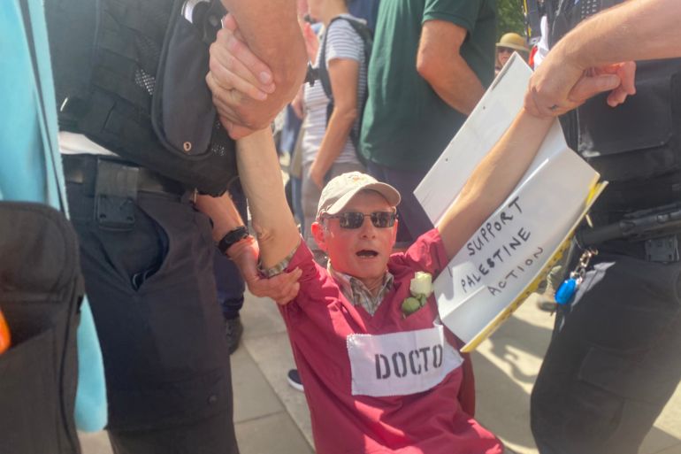 تكبيل متظاهره تحمل وردة بيضاء المصدر النشطاء