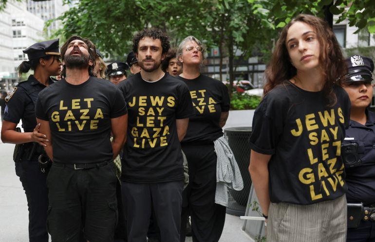 Pro-Palestinian demonstrators, detained by police officers during a protest at the offices of U.S. Senate Minority Leader Chuck Schumer (D-NY) and Sen. Kirsten Gillibrand (D-NY), stand with their hands ziptied, in New York City, U.S., August 1, 2025. REUTERS/Jeenah Moon