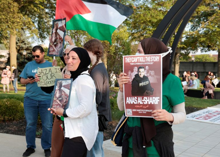 A pro-Palestinian protestor holds a sign in memory of Al Jazeera correspondent Anas al-Sharif, who was killed along with his colleagues during an Israeli airstrike in Gaza on Sunday, amid the ongoing conflict between Israel and Hamas, during a vigil for Gaza in Dearborn, Michigan, U.S., August 14, 2025. REUTERS/Rebecca Cook