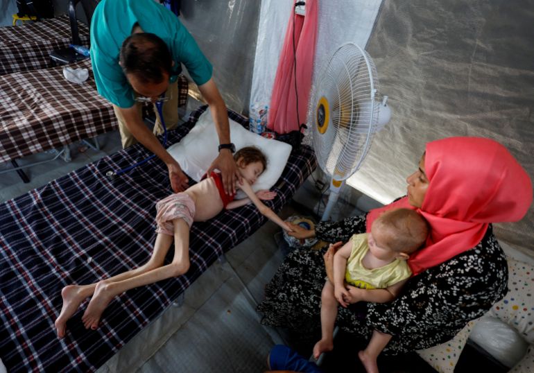 FILE PHOTO: A doctor checks Palestinian girl Jana Ayad, who is malnourished, according to medics, as she receives treatment at the International Medical Corps field hospital, amid the Israel-Hamas conflict, in Deir Al-Balah in the southern Gaza Strip, June 22, 2024. REUTERS/Mohammed Salem/File Photo TPX IMAGES OF THE DAY