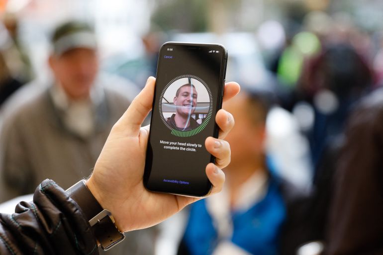 A customer sets up Face ID on his new iPhone X at the Apple Store Union Square on November 3, 2017, in San Francisco, California. Apple's flagship iPhone X hits stores around the world as the company predicts bumper sales despite the handset's eye-watering price tag, and celebrates a surge in profits. (Photo by Elijah Nouvelage / AFP)
