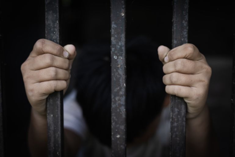 The child captured the iron cage with sadness and despair. The concept of stopping violence against children and human trafficking.