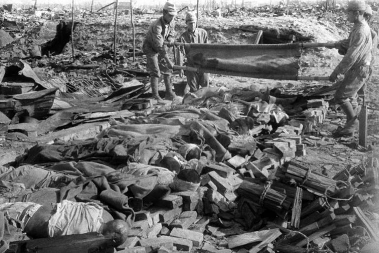 HIROSHIMA, JAPAN - AUGUST 10: Bodies of the worlds first Atomic Bomb victims are uploaded before being cremated next to former Fukuya Department Store on August 10, 1945 in Hiroshima, Japan. (Photo by Hajime Miyatake/The Asahi Shimbun via Getty Images)