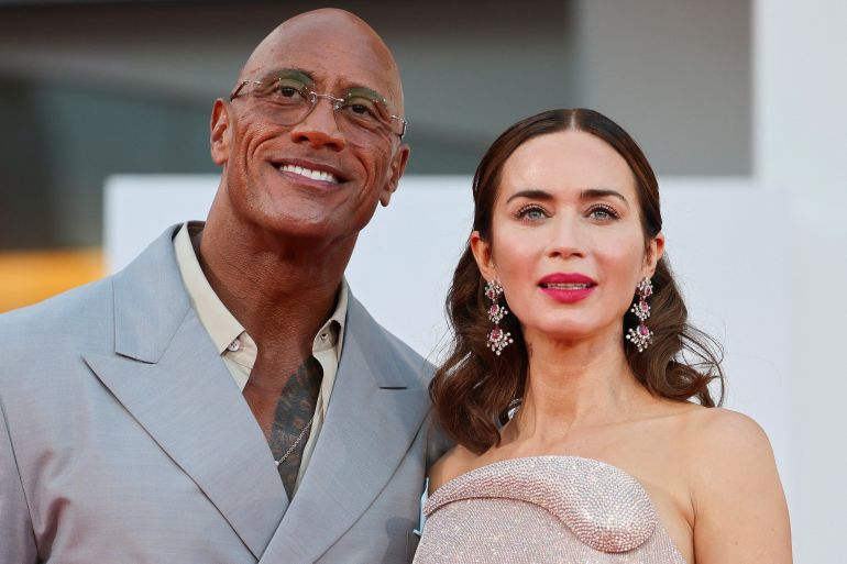 Cast members Dwayne Johnson and Emily Blunt pose on the red carpet during arrivals for the screening "The Smashing Machine" in competition, at the 82nd Venice Film Festival, Venice, Italy, September 1, 2025. REUTERS/Yara Nardi