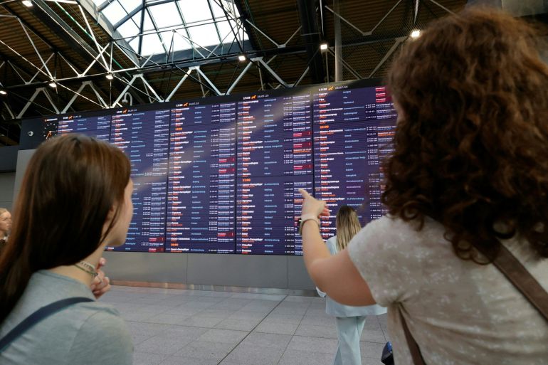 People wait for their flights at the Sheremetyevo International Airport on the outskirts of Moscow on July 28, 2025. A cyberattack on Russia's national airline Aeroflot grounded 42 flights on July 28, officials said, with a Ukrainian and a Belarusian hacker group claiming responsibility for the incident. (Photo by TATYANA MAKEYEVA / AFP)