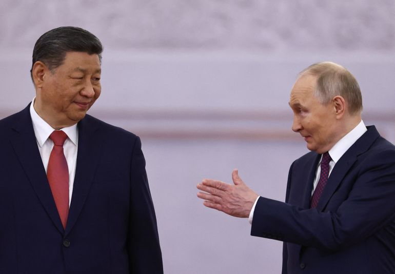 Russian President Vladimir Putin and his Chinese counterpart Xi Jinping attend a welcoming ceremony before their talks at the Kremlin in Moscow on May 8, 2025. (Photo by Evgenia Novozhenina / POOL / AFP)