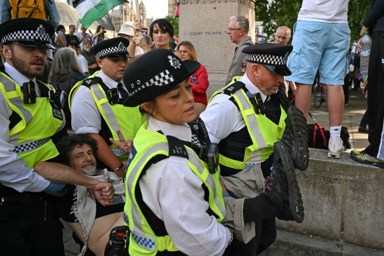 A protester is carried away by police officers at a "Lift The Ban" demonstration in support of the proscribed group Palestine Action, calling for the recently imposed ban to be lifted, in Parliament Square, central London, on September 6, 2025.