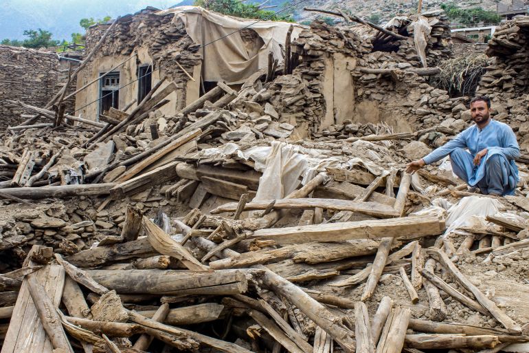 TOPSHOT - An Afghan man sits amid the remains of a damaged house, in the aftermath of an earthquake at the Dara-i-Nur district of Nangarhar province on September 3, 2025.