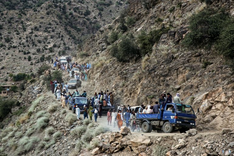 TOPSHOT - Afghans commute along a hillside, in the aftermath of an earthquake at the Nurgal district of Kunar province on September 3, 2025.