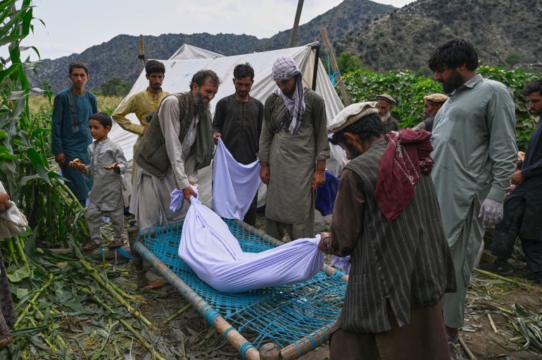 The body of a girl is placed on a bed frame after being pulled from the rubble following Sunday night's powerful 6.0-magnitude earthquake, in a remote area of Kunar province, Afghanistan, Tuesday, Sept. 2, 2025, (AP Photo/Nava Jamshidi)
