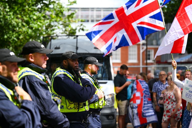 BOURNEMOUTH, ENGLAND - AUGUST 09: Police are seen with anti illegal immigration protesters as they demonstrate outside The Roundhouse hotel, on August 09, 2025 in Bournemouth, England. Protesters and counter-protesters have gathered outside hotels being used to house asylum seekers in recent weeks, as tensions flare over the government's policies on illegal migration, which has reached record numbers this summer. Some far-right politicians and campaigners have faced allegations of fanning the flames by spreading misleading data on crimes committed by foreign nationals, following isolated reports of migrant arrests in connection to sexual assault charges. (Photo by Finnbarr Webster/Getty Images)