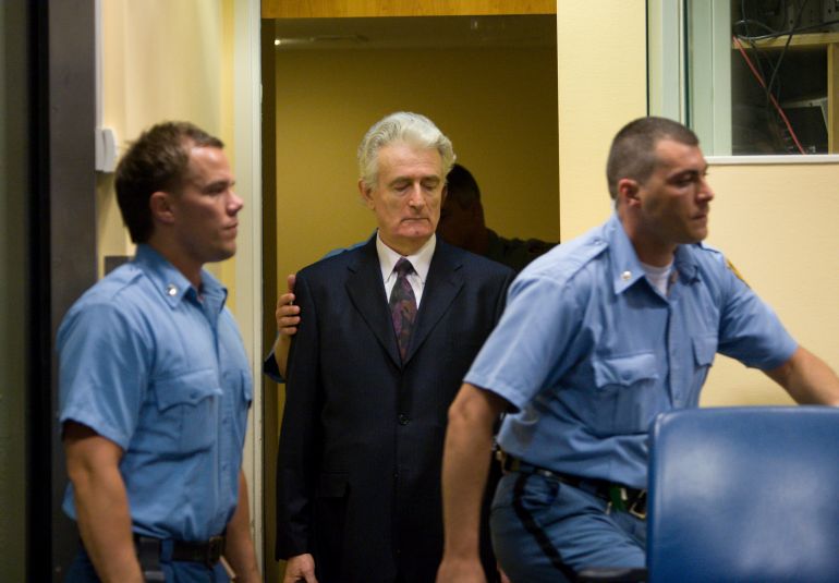 THE HAGUE, NETHERLANDS - JULY 31: Former Bosnian Serb leader Radovan Karadzic (C) makes an initial appearance at the International Criminal Tribunal for the former Yugoslavia (ICTY) on July 31, 2008 in The Hague, The Netherlands. Karadzic was formally charged on 11 counts for war crimes commited during the Bosnian war of the 1990s, following his arrest in Belgrade last week and extradition to the Netherlands after evading capture for 13 years. Karadzic has 30 days to enter a plea. (Photo by Serge Ligtenberg/Getty Images)
